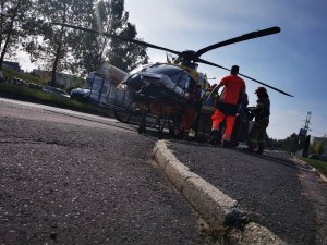 zbliżenie na jezdnię, w tle helikopter pogotowia oraz służby ratownicze