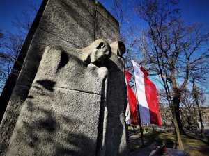 Pomnik Ofiar Faszyzmu w centrum Mikołwa, obok powiewają flagi