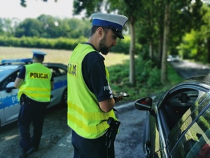 policjanci drogówki w trakcie kontroli kierującego osobówką