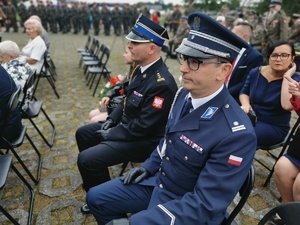 komendant policji siedzi obok pozostałych zaproszonych gości