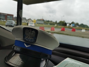 czapka policjanta ruchu drogowego na podszybiu samochodu