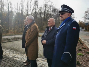 policjant wraz z pozostałymi członkami delegacji przed pomnikiem w Łaziskach Górnych