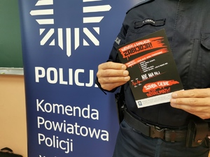 zdjęcia przedstawia ulotkę kampanii antynarkotykowej, w tle baner z logo Policji i napisem Komenda Powiatowa Policji w Mikołowie