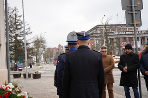 mundurowi oddali hołd pod tablicą, następnie odchodzą  w prawą stronę