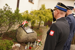 mundurowi oddają hołd poległym policjantom. Scena ma miejsce w Mikołowie, w dzielnicy Bujaków. Zdjęcie wykonane od tyłu