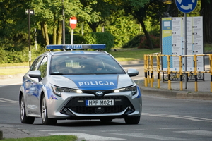 jadący ulicą policyjny radiowóz