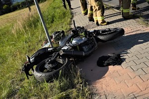 leżący na chodniku uszkodzony motocykl