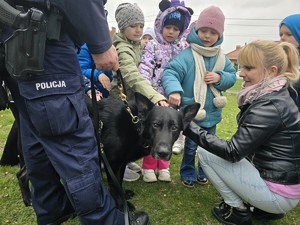 na zdjęciu widać policjanta, psa i dzieci