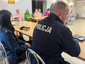 na zdjeciu widać policjanta i uczestników spotkania