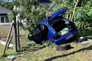 na zdjęciu widać zniszczony samochód na drzewie